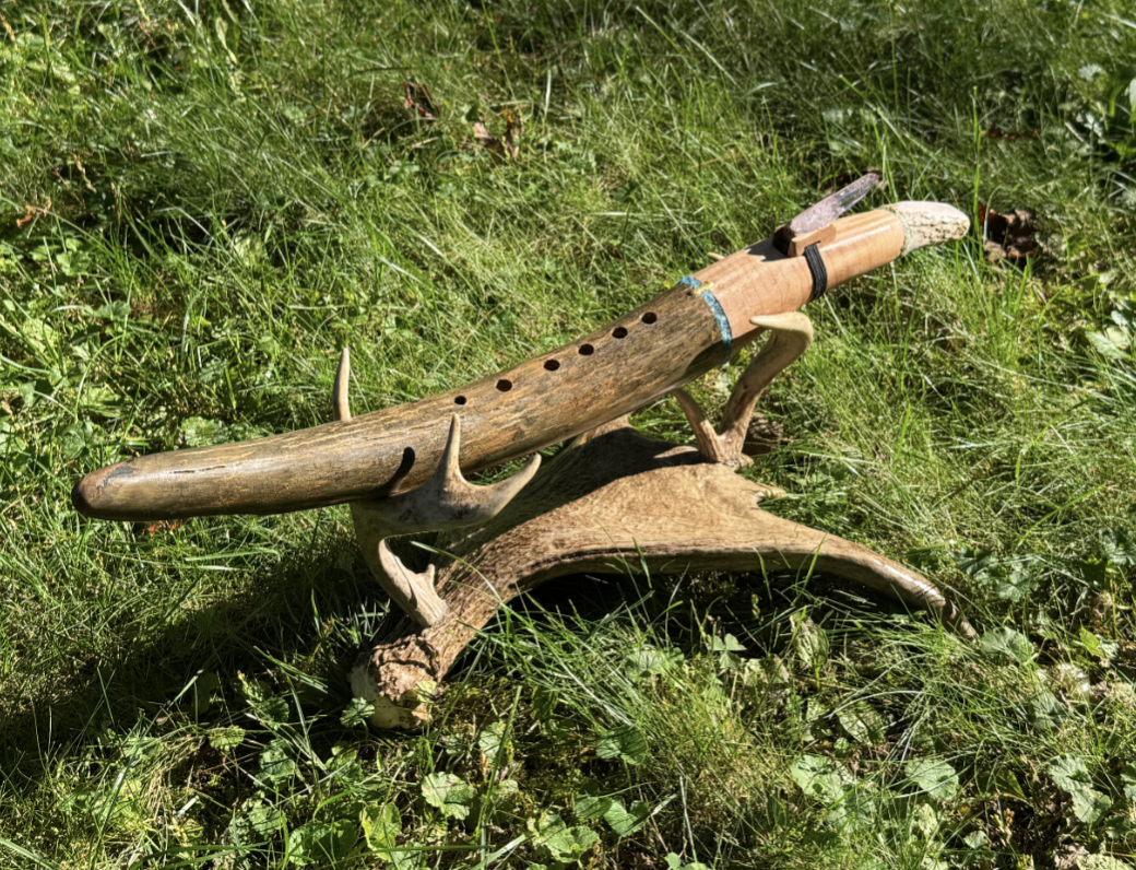 Antler flute on natural stand — full instrument